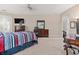 Bedroom has neutral walls, ceiling fan, furniture, plus access to outdoor balcony at 6808 Belmont Ct, Lakewood Ranch, FL 34202