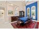 Elegant dining room with high ceilings, chandelier, and large windows with blue accent wall at 6808 Belmont Ct, Lakewood Ranch, FL 34202