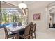 Dining room with a pool view and modern chandelier at 6808 Belmont Ct, Lakewood Ranch, FL 34202