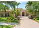 Elegant home featuring manicured landscaping, a brick driveway and double door entry at 6808 Belmont Ct, Lakewood Ranch, FL 34202
