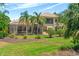Backyard view showcasing the screened lanai with a pool and a well-manicured lawn, enhancing the outdoor experience at 6808 Belmont Ct, Lakewood Ranch, FL 34202