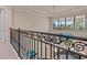 View of railing with ornate ironwork detail overlooking the downstairs, letting light pour into foyer at 6808 Belmont Ct, Lakewood Ranch, FL 34202