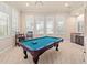 Bright game room with pool table, bar, and plantation shutters for abundant natural light at 6808 Belmont Ct, Lakewood Ranch, FL 34202