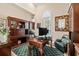 Inviting home office with custom wood built-ins, hardwood flooring, and an elegant writing desk at 6808 Belmont Ct, Lakewood Ranch, FL 34202