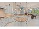 Bright kitchen features an island, tile backsplash, and stainless steel appliances at 6808 Belmont Ct, Lakewood Ranch, FL 34202