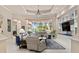 Spacious living area with large windows, stylish furniture, and a built in display cabinet at 6808 Belmont Ct, Lakewood Ranch, FL 34202