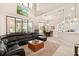 Open-concept living room, kitchen, and dining area with sliding glass doors leading to a screened lanai at 6808 Belmont Ct, Lakewood Ranch, FL 34202