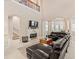 Spacious living room with fireplace, staircase, tile flooring, and large windows providing lots of natural light at 6808 Belmont Ct, Lakewood Ranch, FL 34202