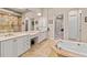 Beautiful bathroom featuring dual sinks, soaking tub and a shower surrounded by decorative tile at 6808 Belmont Ct, Lakewood Ranch, FL 34202