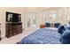 A main bedroom showcasing french doors, plantation shutters, TV and a large dresser at 6808 Belmont Ct, Lakewood Ranch, FL 34202