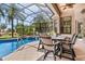 Covered lanai featuring a beautiful pool with connected jacuzzi, perfect for outdoor lounging and entertainment at 6808 Belmont Ct, Lakewood Ranch, FL 34202
