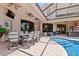 Covered outdoor pool patio features ample seating and entertainment space with a built-in outdoor bar at 6808 Belmont Ct, Lakewood Ranch, FL 34202