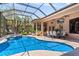 Screened-in pool area featuring a sparkling pool, a jacuzzi, and an outdoor dining space perfect for entertaining at 6808 Belmont Ct, Lakewood Ranch, FL 34202