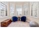 Bright sitting area with natural light, plantation shutters, and two blue armchairs create a cozy and inviting space at 6808 Belmont Ct, Lakewood Ranch, FL 34202