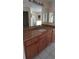 Bathroom featuring a granite countertop and a cherry wood vanity cabinet at 7004 Mauna Loa Blvd, Sarasota, FL 34241