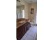 Bathroom with granite counters and tile floors and a view to a gated lanai at 7004 Mauna Loa Blvd, Sarasota, FL 34241