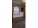 Bathroom featuring a large soaking tub set into a marble surround at 7004 Mauna Loa Blvd, Sarasota, FL 34241