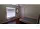 Bare bedroom with hardwood floors, a window with horizontal blinds, and white walls at 7004 Mauna Loa Blvd, Sarasota, FL 34241