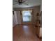 Cozy bedroom with hardwood floors, a window with blinds, and cream-colored walls at 7004 Mauna Loa Blvd, Sarasota, FL 34241