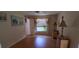 Bright bedroom featuring hardwood floors, a window with blinds, and neutral walls at 7004 Mauna Loa Blvd, Sarasota, FL 34241