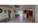 Open dining area featuring neutral walls, ceiling fan, and an adjacent kitchen space at 7004 Mauna Loa Blvd, Sarasota, FL 34241