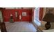 Bright living room featuring tile flooring, a red accent wall, and stylish decorative furnishings at 7004 Mauna Loa Blvd, Sarasota, FL 34241