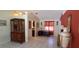 Bright living room featuring tile flooring, a red accent wall, and stylish decorative furnishings at 7004 Mauna Loa Blvd, Sarasota, FL 34241