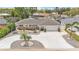 Aerial view of charming home with lush landscaping, a two-car garage, and a spacious driveway at 7205 Pointe West Blvd, Bradenton, FL 34209