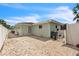 A spacious backyard with a gravel surface, providing a versatile outdoor area for relaxation and entertainment at 7205 Pointe West Blvd, Bradenton, FL 34209