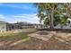 A view of the backyard with mature trees, fire pit and partial view of the screened in pool at 7205 Pointe West Blvd, Bradenton, FL 34209
