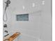 Bright bathroom with updated shower, white tiles, a built-in niche, and modern fixtures at 7205 Pointe West Blvd, Bradenton, FL 34209