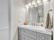 Clean bathroom with white walls, gray vanity, modern fixtures, and white-look floors at 7205 Pointe West Blvd, Bradenton, FL 34209