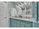Well-lit bathroom with double vanity, granite counters, and tiled shower with glass door at 7205 Pointe West Blvd, Bradenton, FL 34209