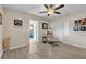 Bedroom featuring wood-look flooring, ceiling fan and an open door to a secondary room at 7205 Pointe West Blvd, Bradenton, FL 34209