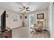 Bedroom featuring wood-look flooring, ceiling fan, and a massage chair at 7205 Pointe West Blvd, Bradenton, FL 34209