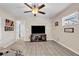 Bedroom featuring wood-look flooring, ceiling fan and a flat screen tv at 7205 Pointe West Blvd, Bradenton, FL 34209