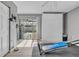 Exercise room features wood-look flooring, a pull-down Murphy bed, and bright natural light at 7205 Pointe West Blvd, Bradenton, FL 34209