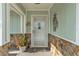 Inviting front porch area with decorative door, stone accents and a welcoming 'home' doormat at 7205 Pointe West Blvd, Bradenton, FL 34209