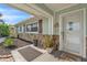 Inviting front porch area with decorative door, stone accents, and a 'welcome' sign at 7205 Pointe West Blvd, Bradenton, FL 34209