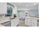 Well-lit kitchen featuring granite countertops, stainless appliances, and view to connected dining area at 7205 Pointe West Blvd, Bradenton, FL 34209