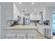 Open-concept kitchen with an island bar, stainless steel appliances, and bright white cabinetry at 7205 Pointe West Blvd, Bradenton, FL 34209