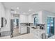 Bright kitchen with stainless steel appliances, modern cabinets, and views of the backyard pool area at 7205 Pointe West Blvd, Bradenton, FL 34209