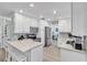 Open kitchen boasts white cabinets, stainless appliances, and a convenient island with barstool seating at 7205 Pointe West Blvd, Bradenton, FL 34209