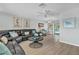 Light and airy living room with tile floors, a ceiling fan, and sliding glass doors at 7205 Pointe West Blvd, Bradenton, FL 34209