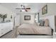 Nicely decorated main bedroom with light colored walls, ceiling fan, and wood-look floors at 7205 Pointe West Blvd, Bradenton, FL 34209