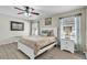 Comfortable main bedroom features coastal decor, ceiling fan, and wood-look floors at 7205 Pointe West Blvd, Bradenton, FL 34209