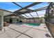 Wide angle shot of screened in pool and spa with outdoor seating and ceiling fans at 7205 Pointe West Blvd, Bradenton, FL 34209