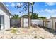 Backyard featuring a storage shed and secure wooden fence at 7321 Caladesia Dr, Sarasota, FL 34243