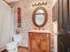 This charming bathroom features rustic decor, including a brick wall and carved wooden accents at 7321 Caladesia Dr, Sarasota, FL 34243