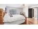 Comfortable bedroom with wood floors, rustic bedframe, and natural light at 7321 Caladesia Dr, Sarasota, FL 34243